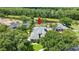 Aerial view of home on a lush lot with a lake view and mature trees at 1653 Promenade Cir, Port Orange, FL 32129