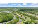Expansive aerial view showcases home near a long lake, nestled within a lush, wooded community at 1653 Promenade Cir, Port Orange, FL 32129