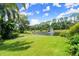 A lush backyard with a picturesque pond and a fountain at 1653 Promenade Cir, Port Orange, FL 32129
