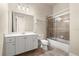 Well-lit bathroom featuring a vanity with double sinks and a glass-enclosed shower/tub combination at 1653 Promenade Cir, Port Orange, FL 32129