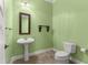 Cozy half bathroom featuring neutral earth tone colors and a pedestal sink at 1653 Promenade Cir, Port Orange, FL 32129