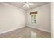Neutral bedroom featuring a large window and tile flooring at 1653 Promenade Cir, Port Orange, FL 32129