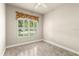 Bright bedroom featuring tile flooring and a window dressed with valances and shutters at 1653 Promenade Cir, Port Orange, FL 32129