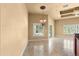Bright dining area with chandelier and views of the screened-in pool at 1653 Promenade Cir, Port Orange, FL 32129