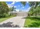 Long, spacious driveway with a three car garage and manicured lawn at 1653 Promenade Cir, Port Orange, FL 32129