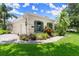 Beautiful home featuring manicured landscaping, a paver walkway, and a three-car garage at 1653 Promenade Cir, Port Orange, FL 32129