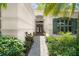 Close-up of the front door and walkway, surrounded by lush landscaping and charming details at 1653 Promenade Cir, Port Orange, FL 32129