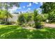 Charming front yard with lush landscaping and a decorative fountain feature at 1653 Promenade Cir, Port Orange, FL 32129