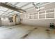 Spacious garage with shelving units, offering ample storage and utility space at 1653 Promenade Cir, Port Orange, FL 32129