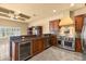 Gourmet kitchen with stainless steel appliances, dark cabinets, and an island at 1653 Promenade Cir, Port Orange, FL 32129
