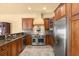 Gourmet kitchen featuring stainless steel appliances, custom cabinetry, and granite countertops at 1653 Promenade Cir, Port Orange, FL 32129