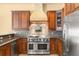 Close-up of kitchen highlighting stainless steel range and custom vent hood at 1653 Promenade Cir, Port Orange, FL 32129