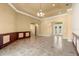 Spacious living room with tiled floors, an arched doorway, and sliding glass doors at 1653 Promenade Cir, Port Orange, FL 32129