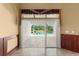 Living room with a sliding glass door with a view of the pool at 1653 Promenade Cir, Port Orange, FL 32129