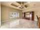 Open living area with tan walls, coffered ceilings, and tile flooring at 1653 Promenade Cir, Port Orange, FL 32129
