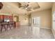 Open-plan living room with tile floors, ceiling fan, and natural light at 1653 Promenade Cir, Port Orange, FL 32129