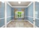 Bright home office featuring blue accent walls, crown molding, and natural light at 1653 Promenade Cir, Port Orange, FL 32129