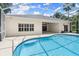 A pristine pool with screened enclosure and a paver patio at 1653 Promenade Cir, Port Orange, FL 32129