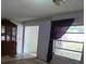 Living room featuring outdated wallpaper, tiled floors, and large dark wood china cabinet at 16880 Se 63Rd Ln, Ocklawaha, FL 32179
