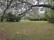 Spacious backyard with mature trees and classic white fencing at 1725 Turtle Hill Rd, Enterprise, FL 32725