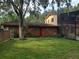 View of the spacious backyard, red door, and a portion of the home's exterior at 1725 Turtle Hill Rd, Enterprise, FL 32725