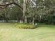 Lush backyard scene with mature oak tree and decorative structure, perfect for relaxing in nature at 1725 Turtle Hill Rd, Enterprise, FL 32725