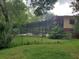 Fenced backyard with a screened-in pool area, mature trees, and a view of the back of the two-story house at 1725 Turtle Hill Rd, Enterprise, FL 32725