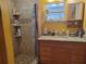 Bathroom featuring granite counters, tile shower, and integrated sink at 1725 Turtle Hill Rd, Enterprise, FL 32725