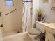This bathroom features a white tiled shower, a plush toilet cover, and a white sink with decorative plant at 1725 Turtle Hill Rd, Enterprise, FL 32725