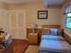 Cozy bedroom features a comfortable bed, wood floors, and bright natural light at 1725 Turtle Hill Rd, Enterprise, FL 32725