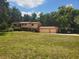 Charming two-story home with a large front yard, two car garage, and an attached car port at 1725 Turtle Hill Rd, Enterprise, FL 32725