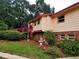 Exterior of home with a landscaped yard with trees and shrubbery at 1725 Turtle Hill Rd, Enterprise, FL 32725