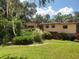 Exterior view of the home with a well-manicured lawn and mature landscaping at 1725 Turtle Hill Rd, Enterprise, FL 32725