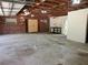 Large garage with concrete floor, brick wall and double yellow doors leading outside at 1725 Turtle Hill Rd, Enterprise, FL 32725