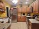 Warm kitchen with wooden cabinets, granite countertops, stainless steel refrigerator and recessed lighting at 1725 Turtle Hill Rd, Enterprise, FL 32725