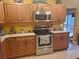 Kitchen featuring wooden cabinets, stainless steel microwave and oven with ceramic tile flooring at 1725 Turtle Hill Rd, Enterprise, FL 32725