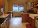 Kitchen with stainless steel appliances, tile floors, wood cabinets, and a farmhouse sink at 1725 Turtle Hill Rd, Enterprise, FL 32725