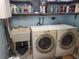 Laundry room with utility sink, washer, dryer, and shelving at 1725 Turtle Hill Rd, Enterprise, FL 32725