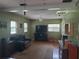 The living room has hardwood floors, a ceiling fan, and lots of light from the windows at 1725 Turtle Hill Rd, Enterprise, FL 32725