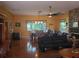 Open concept living room and dining area featuring hardwood floors and a stone fireplace at 1725 Turtle Hill Rd, Enterprise, FL 32725
