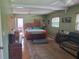 Spacious main bedroom with wood accents, ceiling fan, and access to outdoor deck at 1725 Turtle Hill Rd, Enterprise, FL 32725