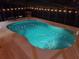 Night view of the in-ground pool featuring patio lighting and outdoor furniture under a screened enclosure at 1725 Turtle Hill Rd, Enterprise, FL 32725