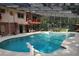 Relaxing covered outdoor pool area with dining and lounge furniture at 1725 Turtle Hill Rd, Enterprise, FL 32725