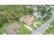Aerial view of a well-kept home with a screened-in pool, solar panels, and a scenic pond view at 18 Foxfords, Ormond Beach, FL 32174