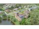 Aerial view features a home with solar panels, screened-in pool, and a serene pond-side setting at 18 Foxfords, Ormond Beach, FL 32174