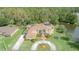 Aerial view of home with circular driveway, landscaping, and pond in backyard at 18 Foxfords, Ormond Beach, FL 32174