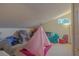 Cozy attic space featuring a play teepee, colorful furniture, and a bright window at 18 Foxfords, Ormond Beach, FL 32174