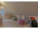 Attic space with decor, including paintings, bean bag chairs, and a dress form near a round window at 18 Foxfords, Ormond Beach, FL 32174