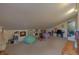 Attic space with a variety of decor, including paintings, bean bag chairs, and a rocking chair at 18 Foxfords, Ormond Beach, FL 32174