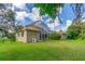 Spacious backyard with a screened lanai offers privacy and shade for enjoying outdoor living, plus a large grassy area at 18 Foxfords, Ormond Beach, FL 32174
